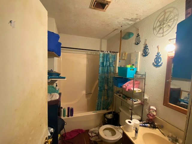 full bathroom featuring toilet, vanity, shower / bath combination with curtain, and a textured ceiling