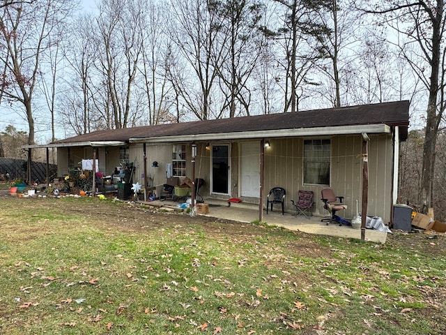 rear view of property with a patio area and a lawn