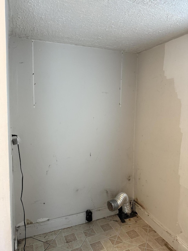 laundry area featuring a textured ceiling