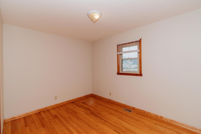 spare room featuring hardwood / wood-style floors