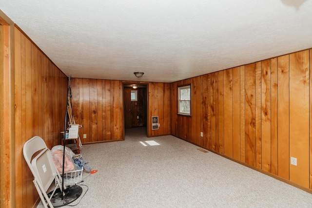 interior space featuring carpet flooring and heating unit