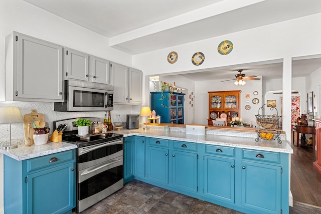 kitchen featuring blue cabinetry, backsplash, kitchen peninsula, and stainless steel appliances