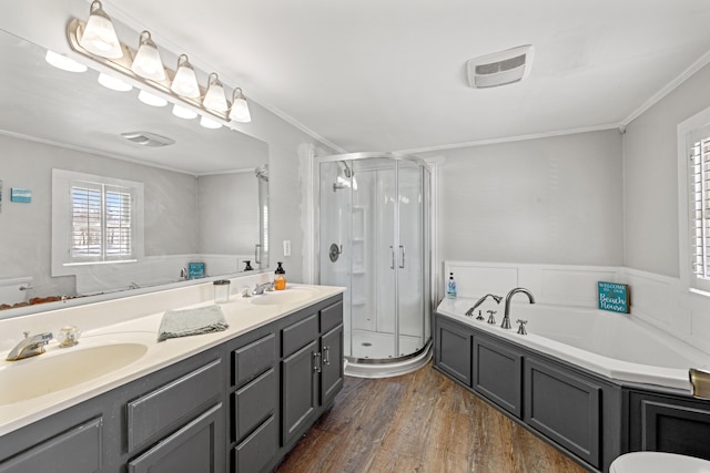 bathroom with hardwood / wood-style floors, vanity, crown molding, and independent shower and bath