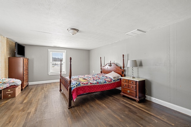 bedroom featuring dark hardwood / wood-style floors and a textured ceiling