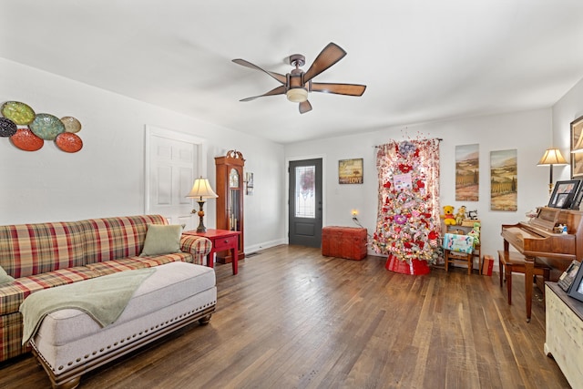 living room with ceiling fan and dark hardwood / wood-style flooring