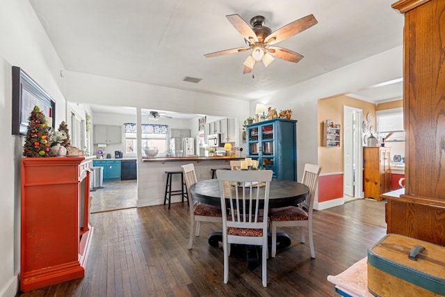 dining area featuring ceiling fan and dark hardwood / wood-style flooring