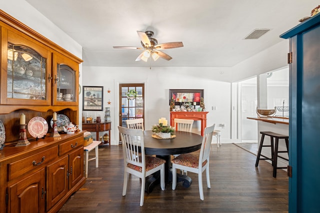 dining space with dark wood-type flooring and ceiling fan