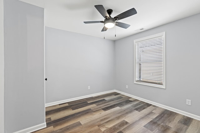 unfurnished room with ceiling fan and dark hardwood / wood-style floors