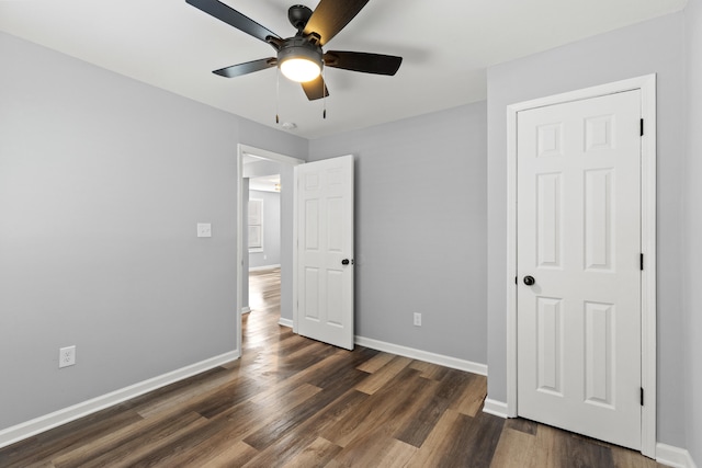 unfurnished bedroom with ceiling fan and dark hardwood / wood-style floors