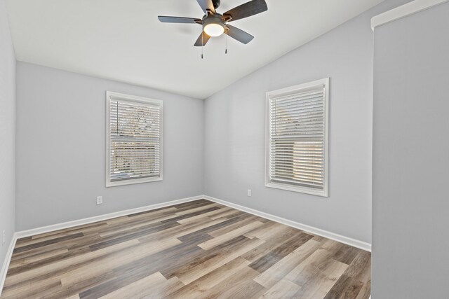 spare room with ceiling fan, wood-type flooring, and lofted ceiling