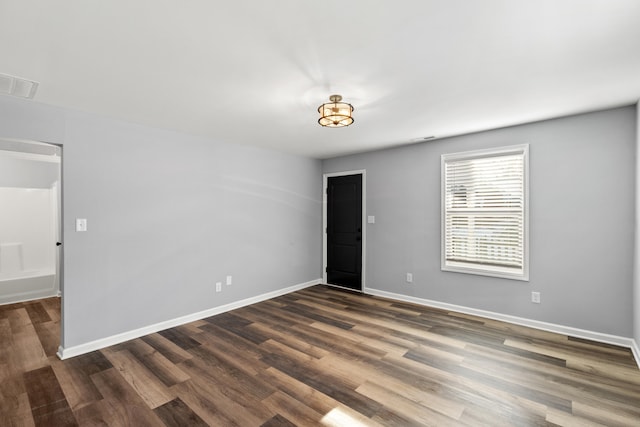 spare room featuring dark wood-type flooring