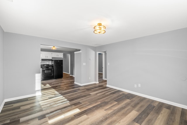 unfurnished living room featuring dark wood-type flooring