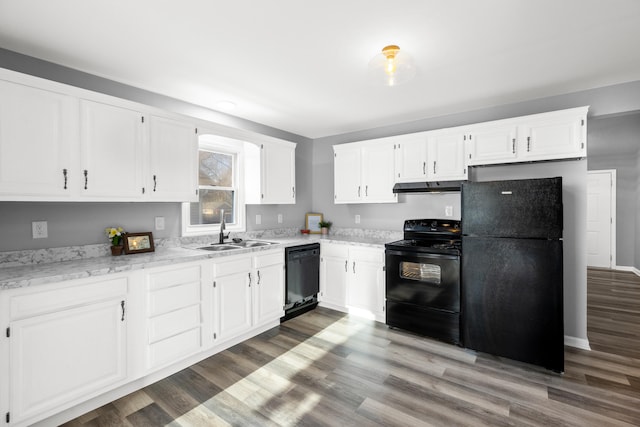 kitchen featuring dark wood-type flooring, sink, white cabinetry, and black appliances