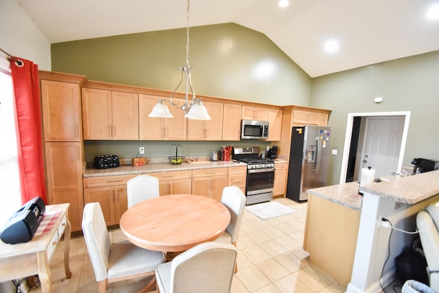 kitchen with appliances with stainless steel finishes, light brown cabinets, light tile patterned flooring, high vaulted ceiling, and pendant lighting