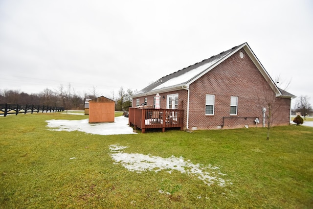 view of side of home featuring a lawn and a wooden deck