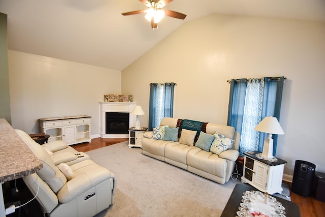 living room featuring ceiling fan, lofted ceiling, and hardwood / wood-style floors