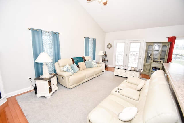 living room featuring ceiling fan, hardwood / wood-style flooring, and high vaulted ceiling