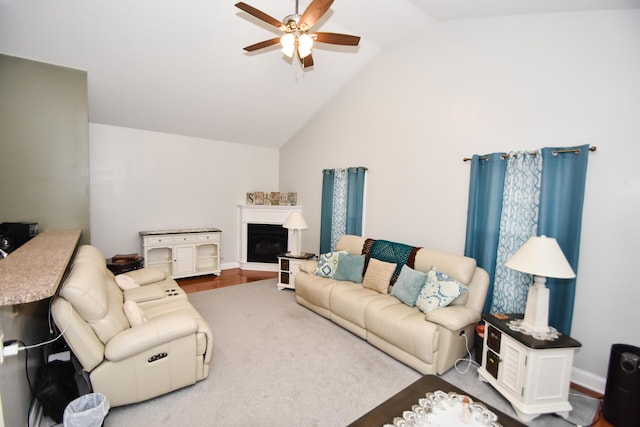 living room featuring vaulted ceiling, ceiling fan, and hardwood / wood-style floors