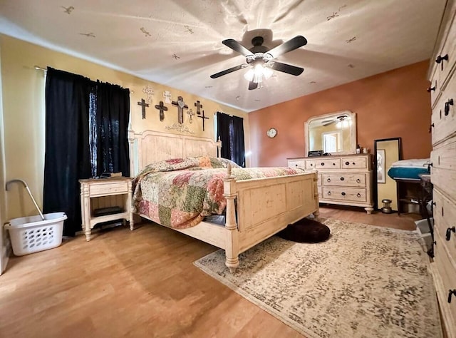 bedroom with ceiling fan and wood-type flooring