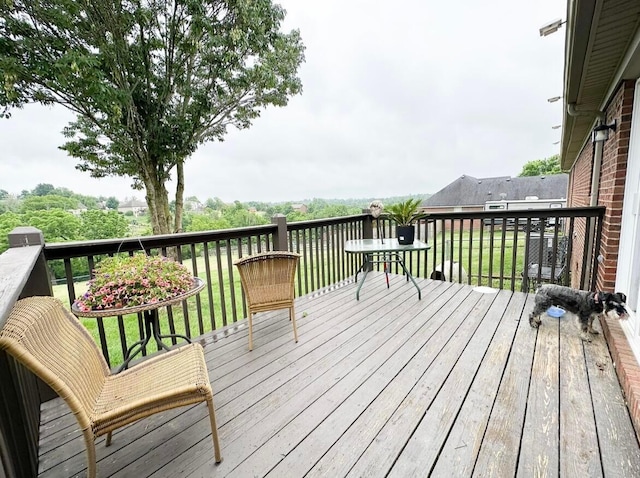 wooden terrace featuring a lawn