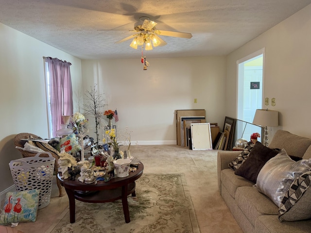 living room featuring ceiling fan and a textured ceiling