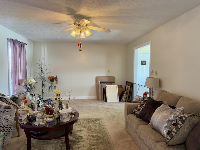 living room featuring ceiling fan and a textured ceiling