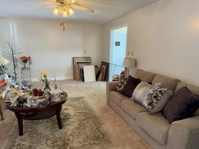 carpeted living room with ceiling fan and a textured ceiling