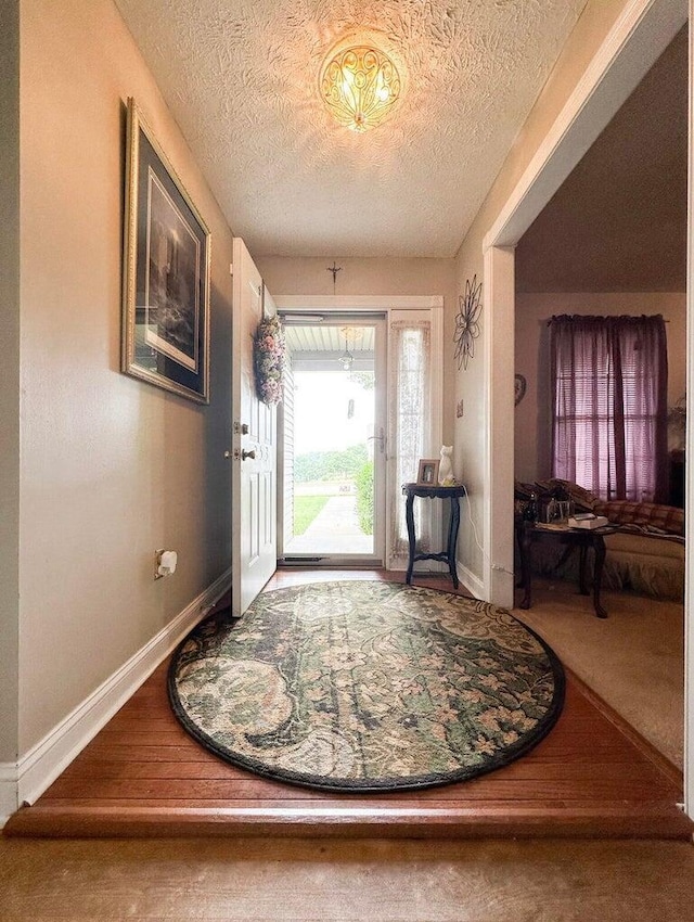 foyer featuring a textured ceiling and hardwood / wood-style floors