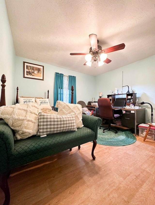 bedroom with a textured ceiling and ceiling fan