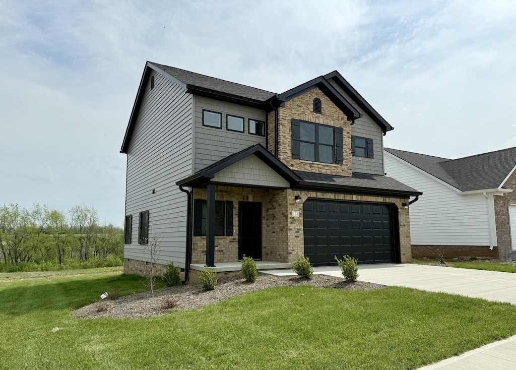 craftsman-style home with a front lawn, driveway, and a garage