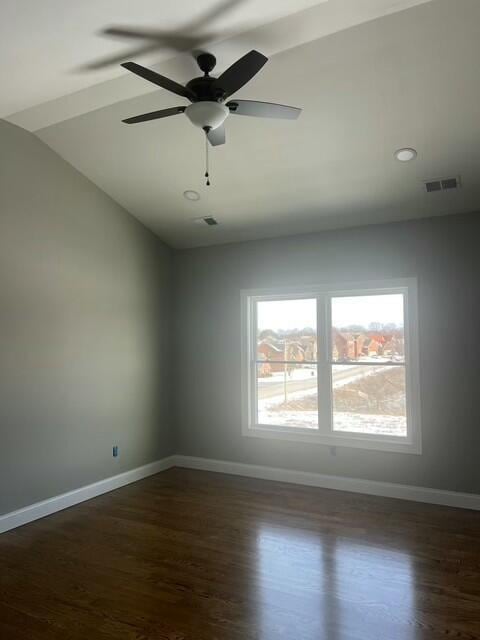 spare room with ceiling fan, lofted ceiling, and dark hardwood / wood-style floors