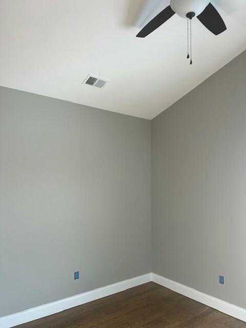 unfurnished room with ceiling fan and dark hardwood / wood-style flooring