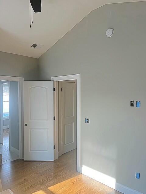 interior space featuring lofted ceiling, light wood-type flooring, and ceiling fan