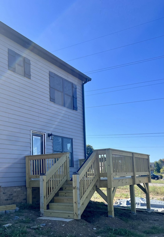 back of property with a wooden deck