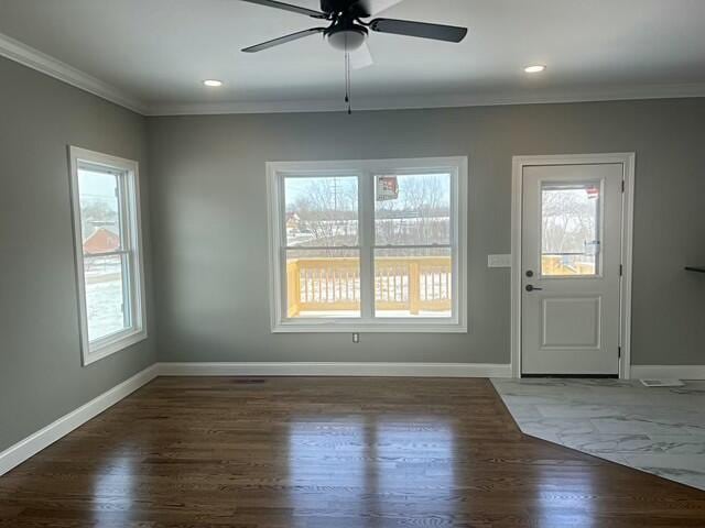 interior space with ceiling fan, dark hardwood / wood-style flooring, and crown molding