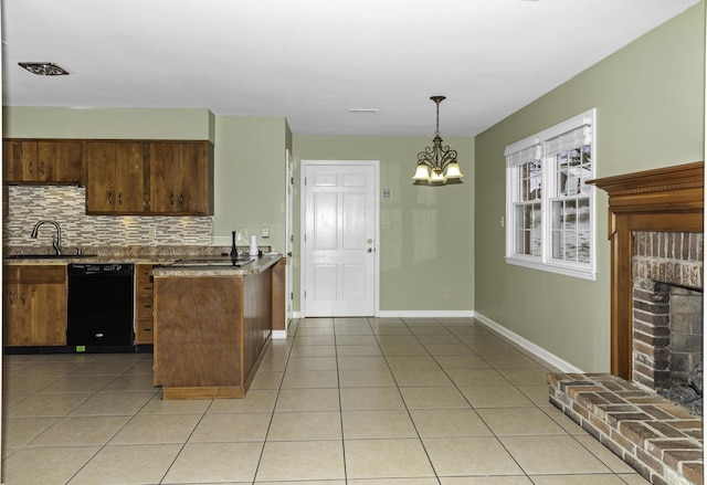 kitchen featuring decorative light fixtures, black dishwasher, tasteful backsplash, sink, and a chandelier