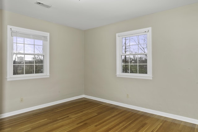 spare room featuring dark wood-type flooring