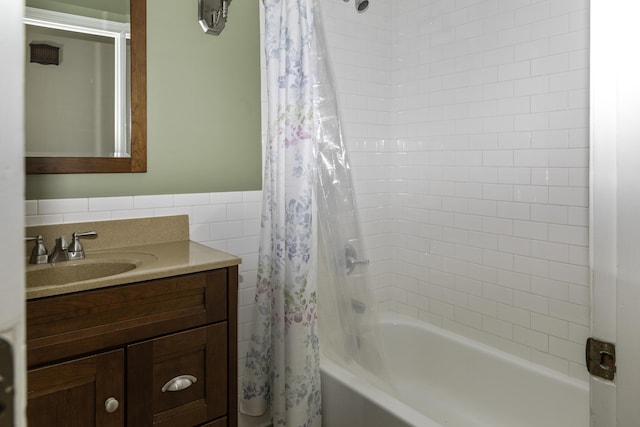 bathroom with vanity, shower / tub combo, and tile walls