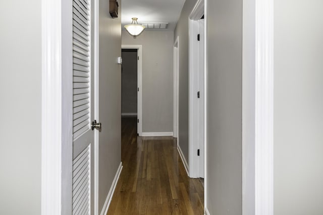 corridor with dark wood-type flooring