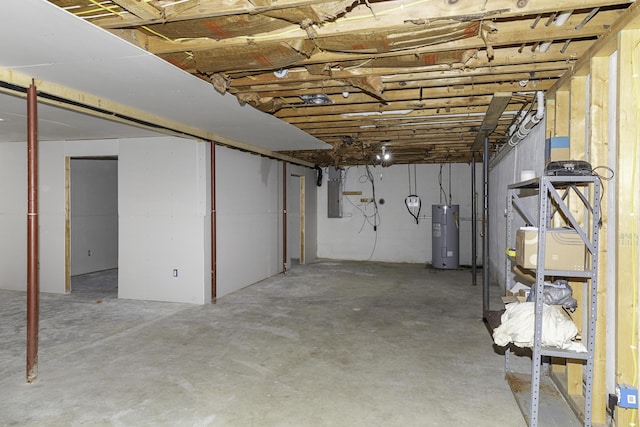 basement featuring electric panel and electric water heater