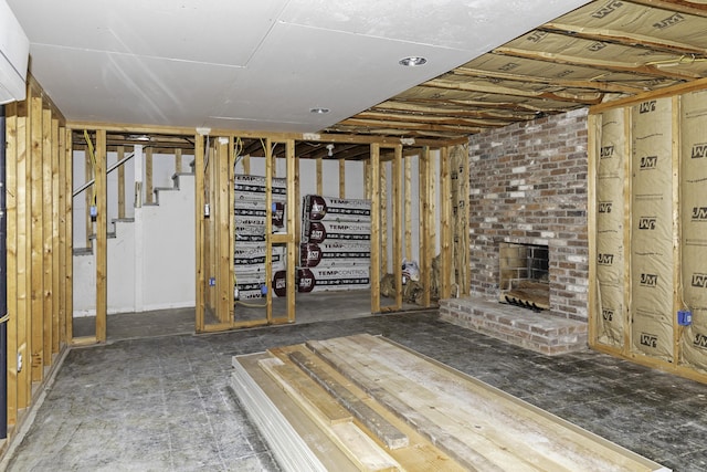 basement featuring a brick fireplace