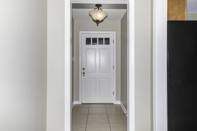 doorway with light tile patterned flooring