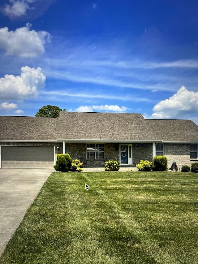 ranch-style house with a garage and a front yard