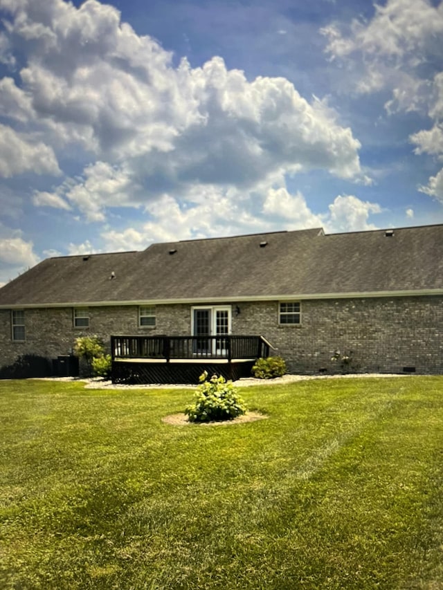 back of property featuring central AC unit, a deck, and a lawn