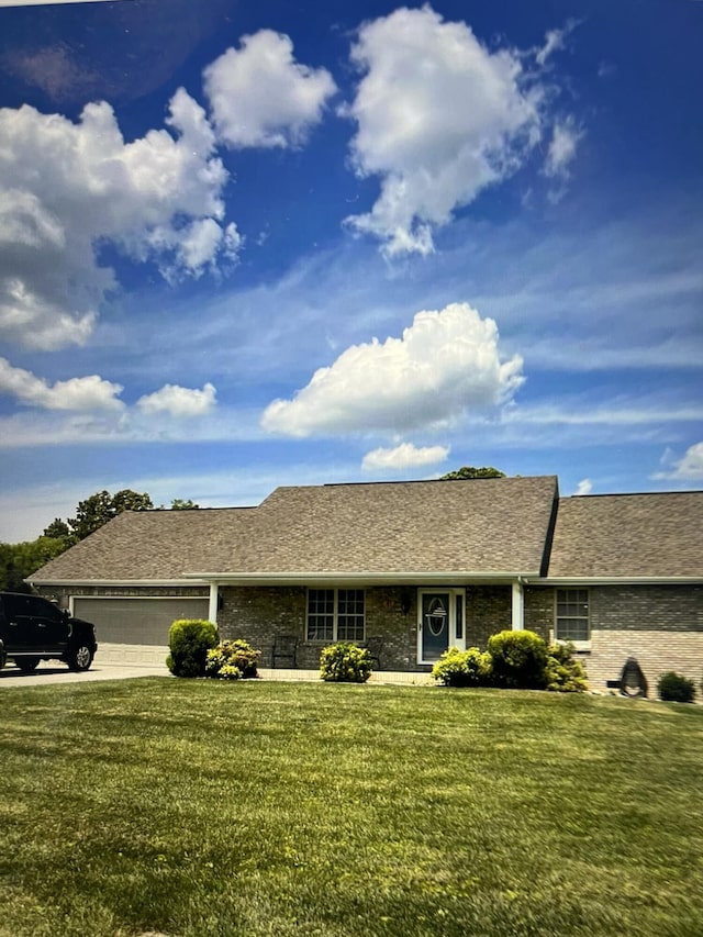 ranch-style house with a garage and a front lawn