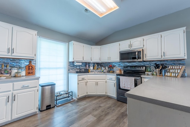 1216 Maple Hill Dr, Somerset, KY 42503 - kitchen with stainless steel appliances, backsplash, light wood-style flooring, white cabinets, and lofted ceiling
