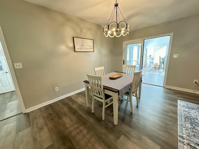 dining space featuring a notable chandelier and dark hardwood / wood-style floors