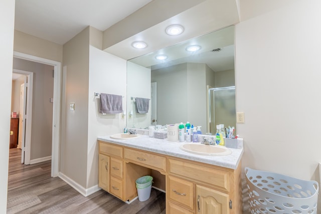 1216 Maple Hill Dr, Somerset, KY 42503 - full bathroom featuring wood finished floors, double vanity, a stall shower, and baseboards