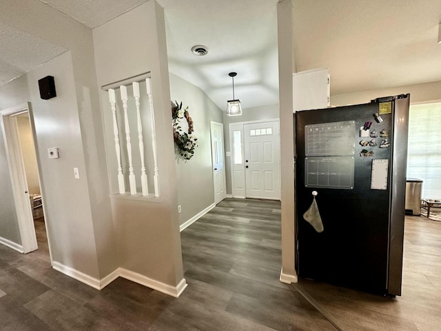 foyer entrance with vaulted ceiling and dark hardwood / wood-style floors