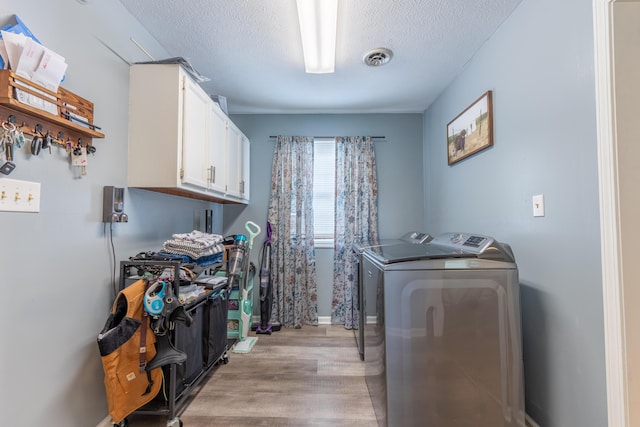 1216 Maple Hill Dr, Somerset, KY 42503 - laundry area with independent washer and dryer, cabinet space, light wood-style flooring, and a textured ceiling